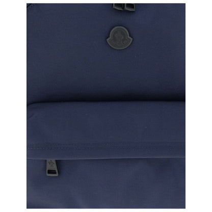 Moncler Blue Nylon Backpack with leather trim, metal logo, water-repellent fabric, adjustable straps, and zippered pockets for convenience.