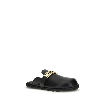 Moschino Black Calf Leather Bos Taurus Mules with golden logo plaque and rounded toe, perfect for adding glamour to any look.