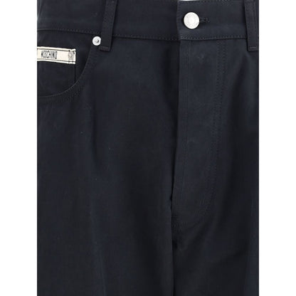 Close-up of Moschino Black Cotton Casual Pants with signature front patch and straight-leg cut, featuring button and zip closure.