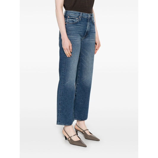 Woman wearing Mother Jeans Blue with whiskering effect, five pockets, and ankle length fit.