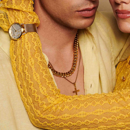 Elegant couple adorned with a gold necklace and watch, showcasing luxurious fashion accessories and style.