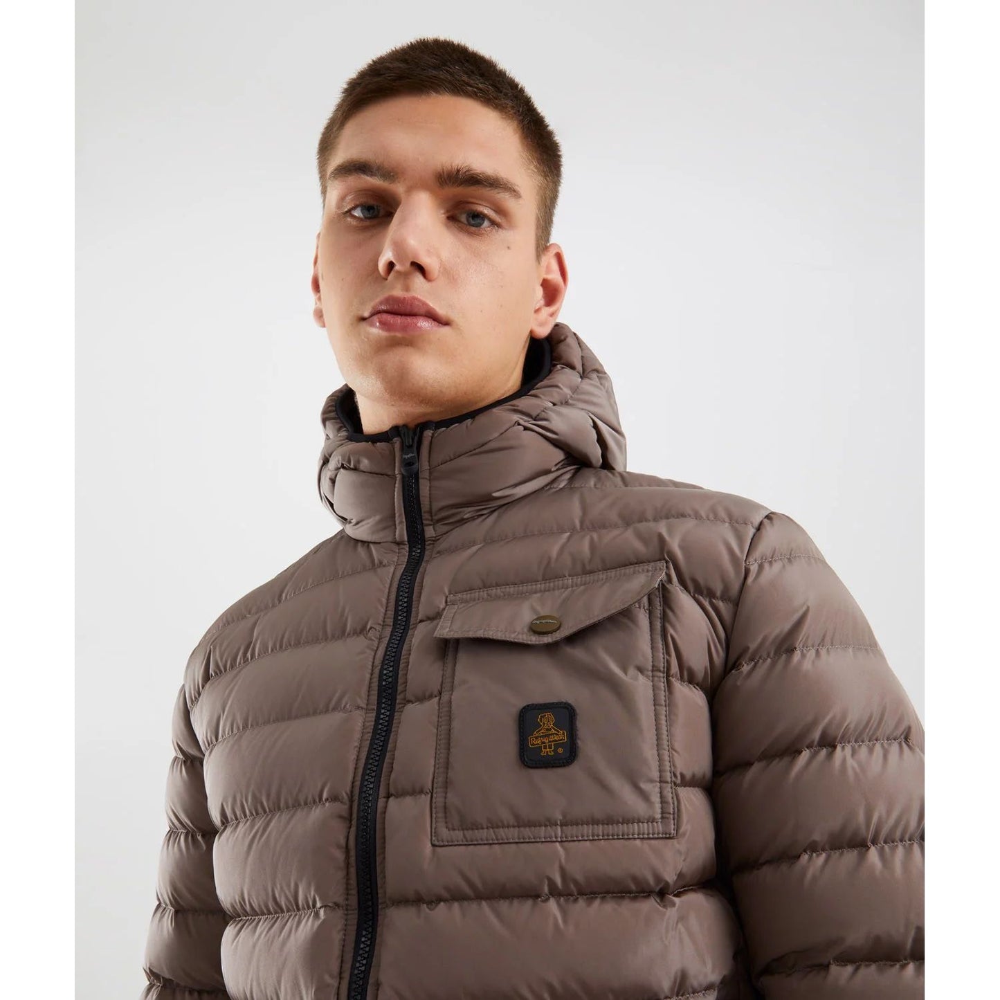 Refrigiwear Beige Nylon Men Jacket with hood and chest pocket, worn by model in urban setting, highlighting style and functionality.