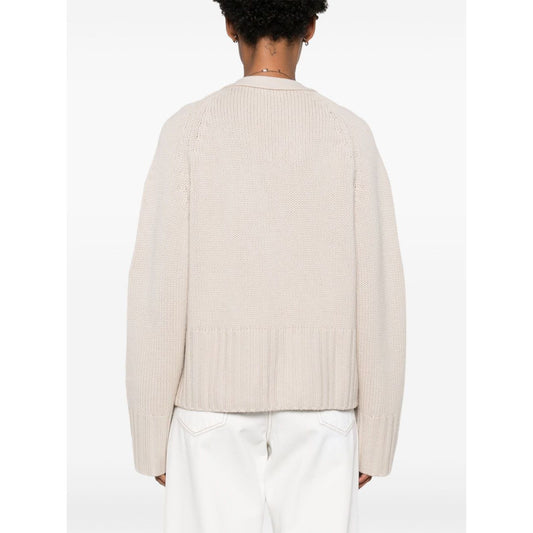 Back view of SOFT GOAT Sweaters Ivory cashmere cardigan with light beige color, ribbed trim, and long sleeves.