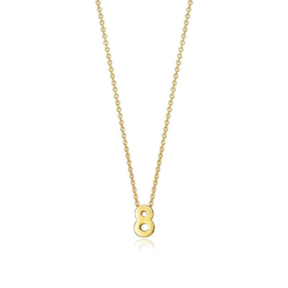 Gold necklace with number eight pendant on chain over white background