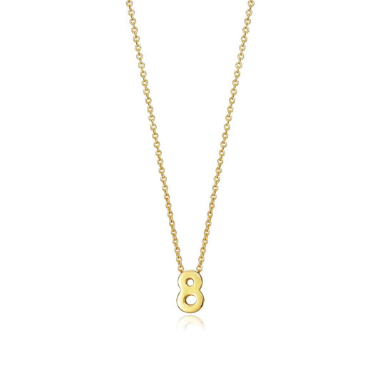 Gold necklace with number eight pendant on chain over white background