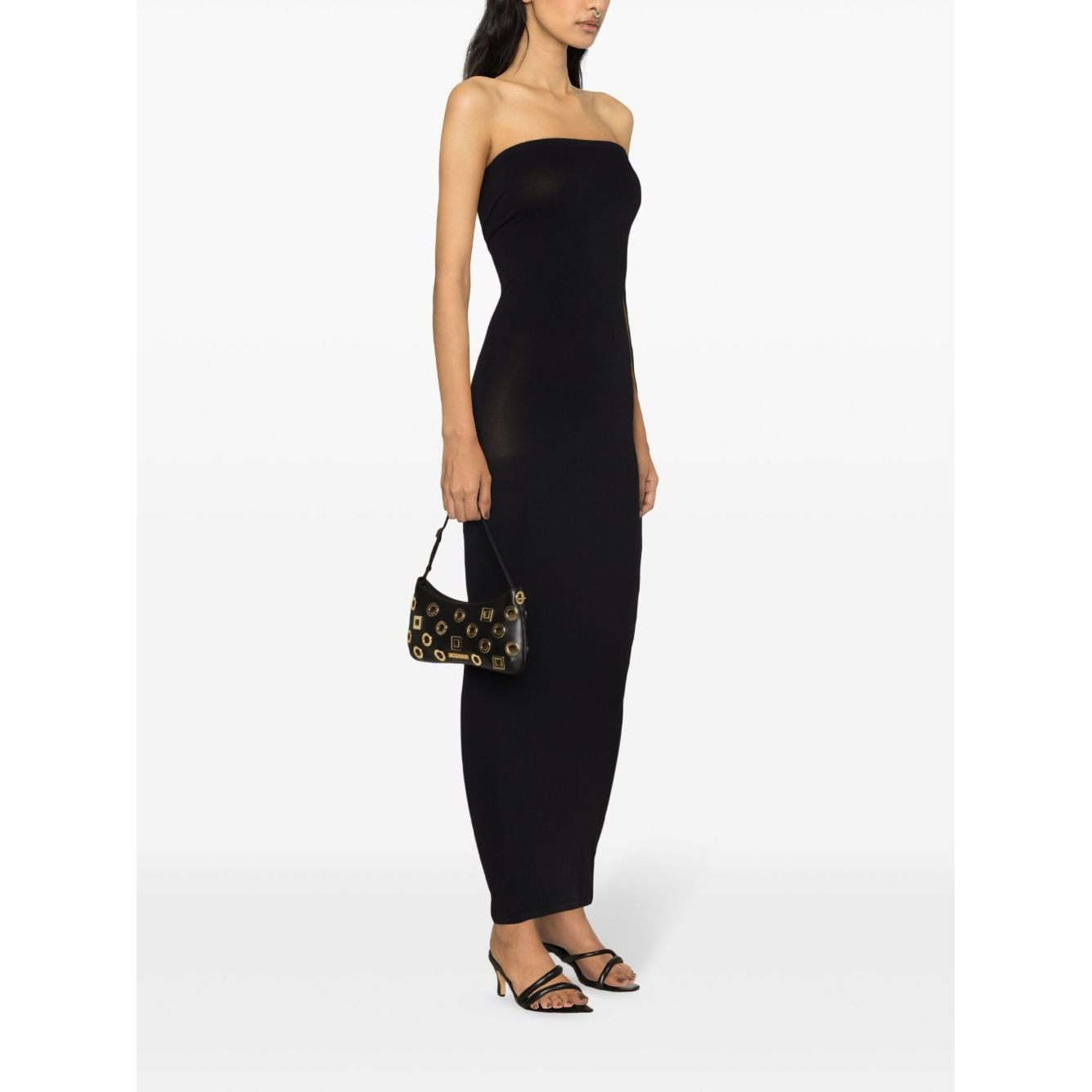 Woman wearing Wolford Dresses Black, strapless ribbed knit tube dress with an elasticated hem, paired with a small black handbag and heels.