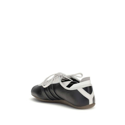 Side view of Y-3 Black Calf Leather Bos Taurus Low Top Sneakers with striped detail, modern design, and flat rubber sole.