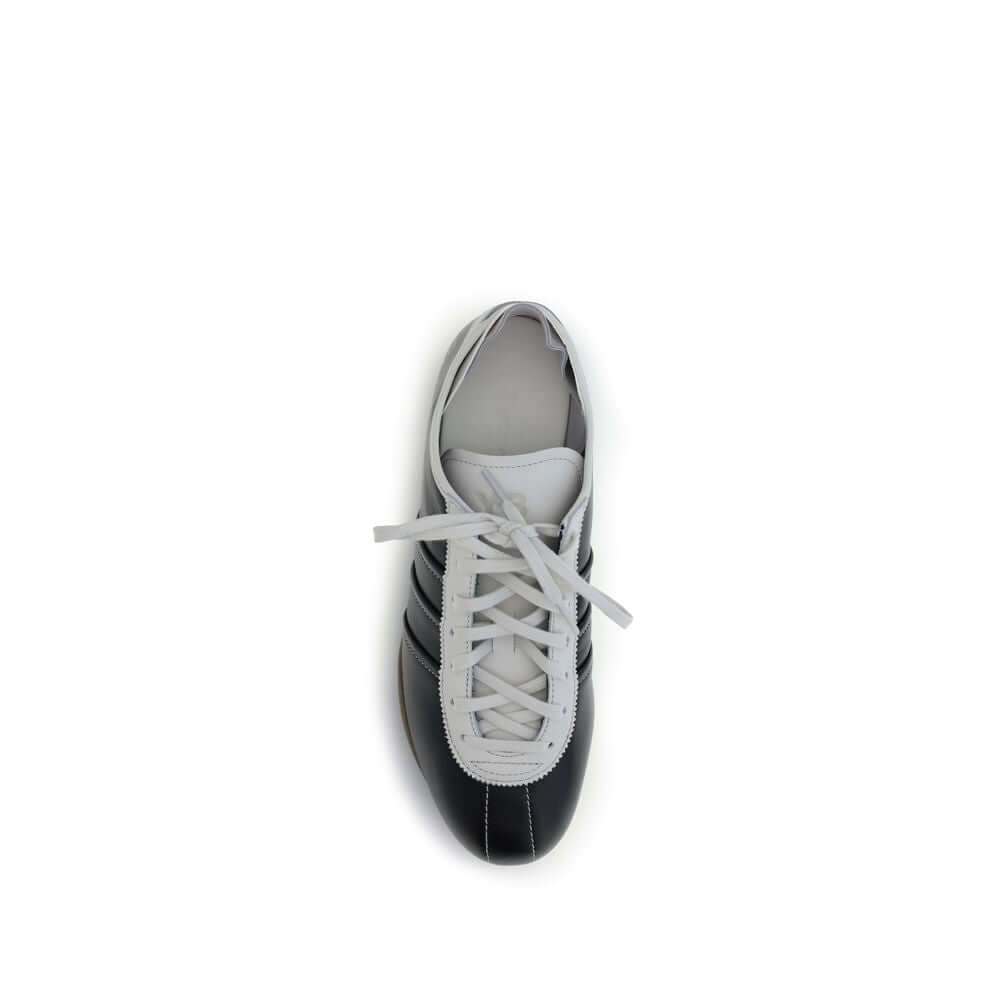 Y-3 Black Calf Leather Bos Taurus Low Top Sneakers with striped detail, top view showing white laces and flat rubber sole.