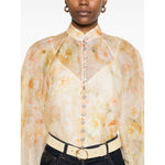 Light yellow Zimmermann Crush Shirt with floral print, crystal buttons, and puff sleeves.